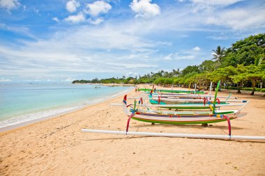 Beautiful tropical beach with fisherman's boats in Nusa Dua on B clipart