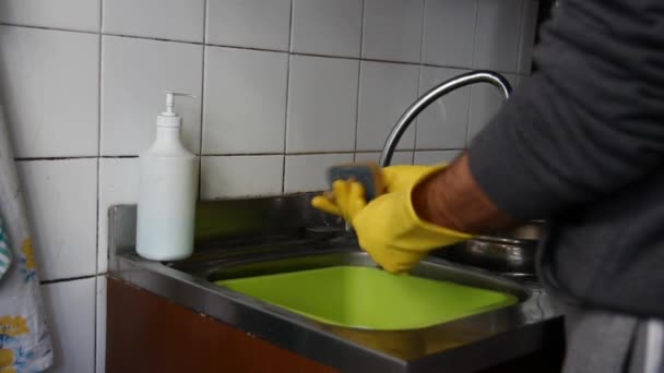 Мужчина моет посуду на кухне — стоковое видео