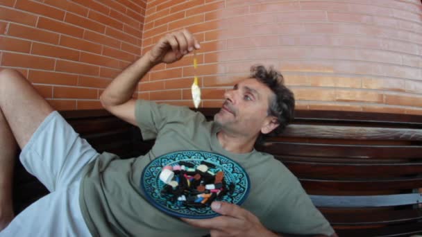 Hombre comiendo caramelos de jalea — Vídeos de Stock