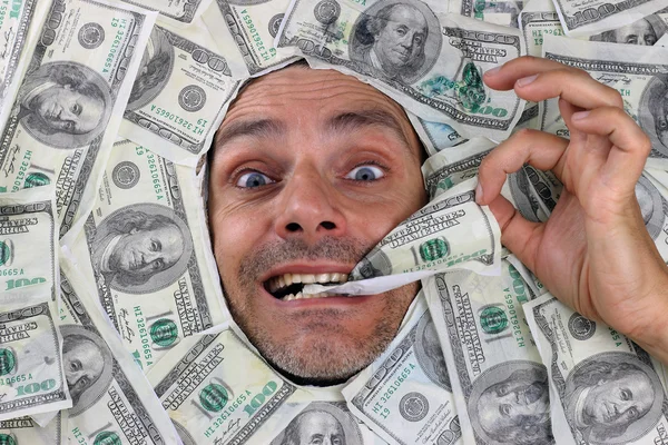 Man under a bed of dollars — Stock Photo, Image