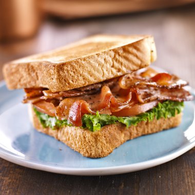 BLT bacon lettuce tomato sandwich with toast off to the side. clipart