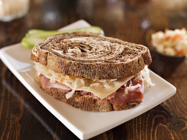 Reuben sandwich with kosher dill pickle and coleslaw — Stock Photo, Image