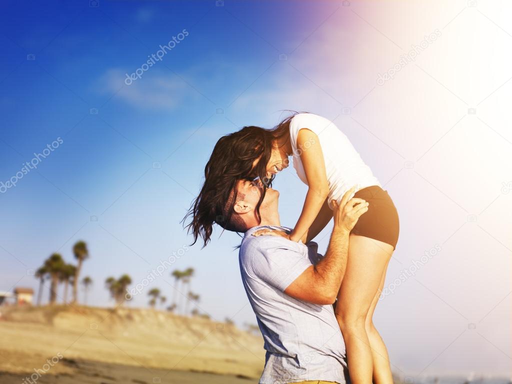 Romantic couple in intimate moment on the beach.