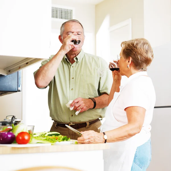 Elderly married couple drinking a toast — Stock Photo, Image