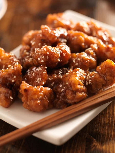 Chinese sesame chicken with chopsticks — Stock Photo, Image