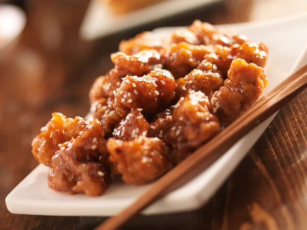 Chinese sesame chicken with chopsticks — Stock Photo, Image