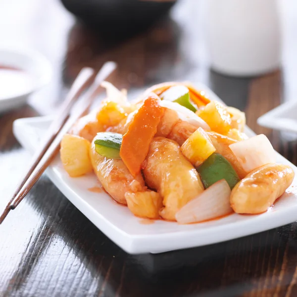 Chinese sweet and sour chicken with chopsticks — Stock Photo, Image