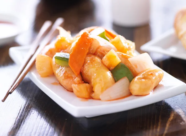 Chinese sweet and sour chicken with chopsticks — Stock Photo, Image