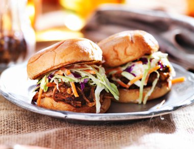 Pulled pork sandwiches with bbq sauce and slaw clipart