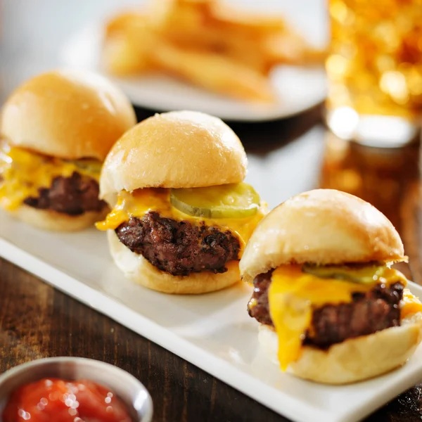 Burger sliders with melted cheese and pickle — Stock Photo, Image