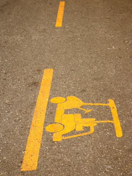 Yellow golf land on black asphalt surface — Stock Photo, Image