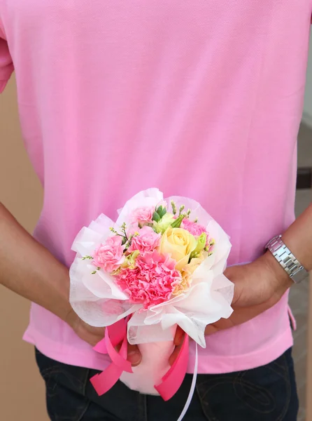 Beautiful flower hiding behide man back — Stock Photo, Image