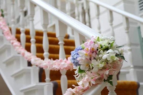 Flowers arrangement on the railing — Stock Photo, Image