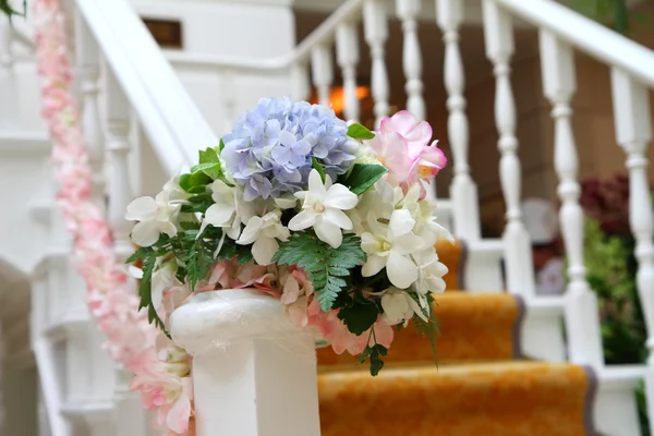 Flowers arrangement on the railing — Stock Photo, Image