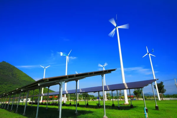Wind turbine generator and solar energy panels — Stock Photo, Image