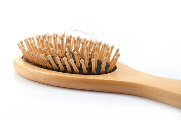 Wooden comb brush with lost hair — Stock Photo, Image