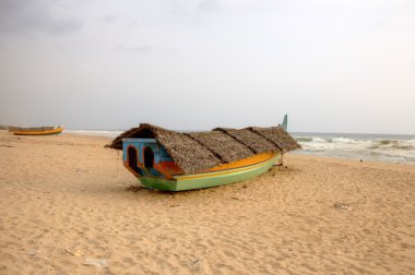 Fishing boat on beach. Kerala, India clipart