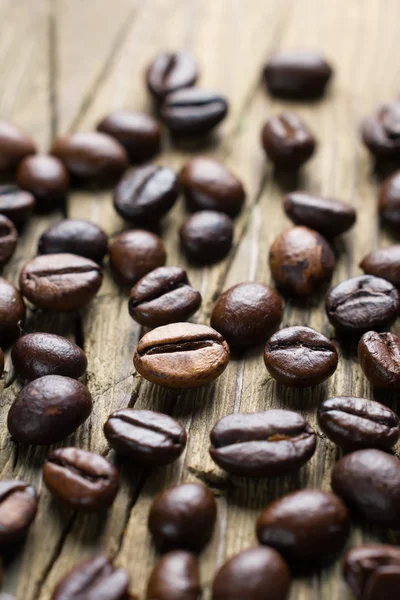 Coffee beans on the vintage wooden background — Stock Photo, Image