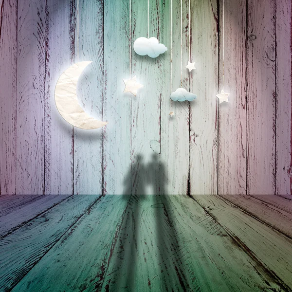 Romantic picture with loving couple looking at the paper stars, the clouds and the moon on a vintage wooden background — Stock Photo, Image