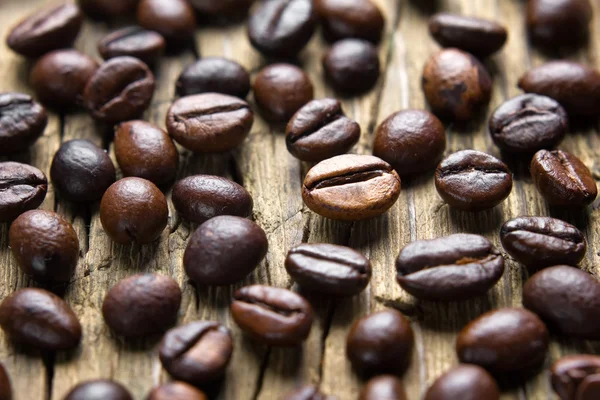 Coffee beans on the vintage wooden table — Stock Photo, Image