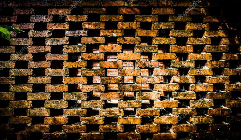Repeating brick pattern with spaces and a solid brick wall through the