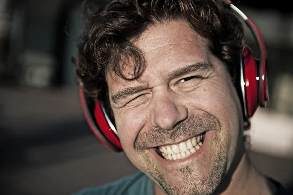Uśmiechnięty mężczyzna w czerwonej słuchawki — Zdjęcie stockowe