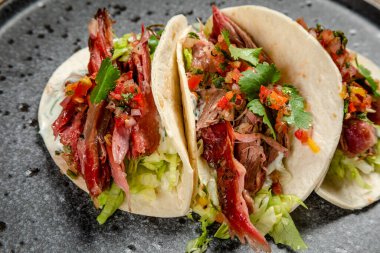 Tütsülenmiş biftek, sebze ve beyaz soslu taco.