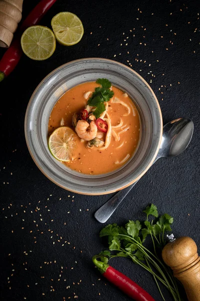 Tom yum soup on a black decorated background — Foto Stock