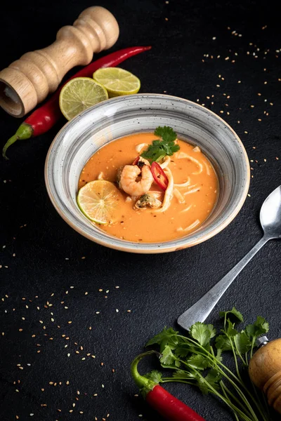 Tom yum soup on a black decorated background — Foto Stock