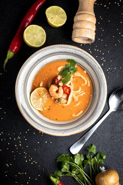 Tom yum soup on a black decorated background — Foto Stock