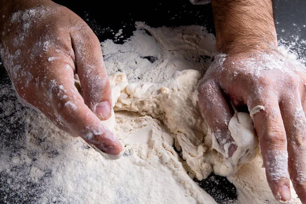 Chef Kneads Dough Dark Background Table Strewn Flour — Stock Fotó