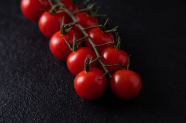close up cherry tomatoes on dark background