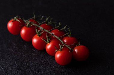 close up cherry tomatoes on dark background