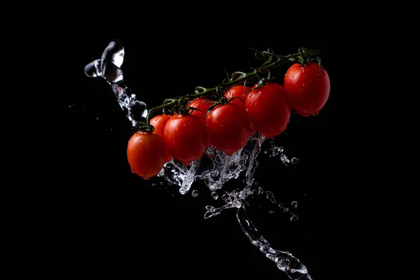 Freeze Motion Cherry Tomatoes Black Background Splashing Water — Zdjęcie stockowe