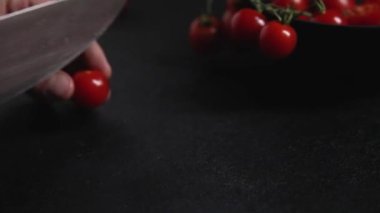 slices cherry tomatoes on a dark background