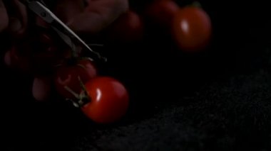 slices cherry tomatoes on a dark background