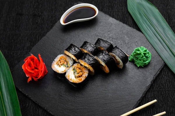 Sushi Rolls Laid Out Dark Background Decorated Bamboo Leaves Chopsticks — Stock Photo, Image