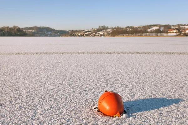 Buoy trapped in the frozen lake — Stock Photo, Image