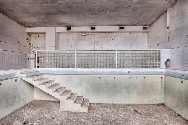 Swimming pool in a ruined building — Stock Photo, Image