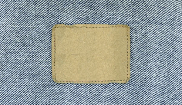 Blank leather jeans label sewed on a blue jeans. — Stock Photo, Image