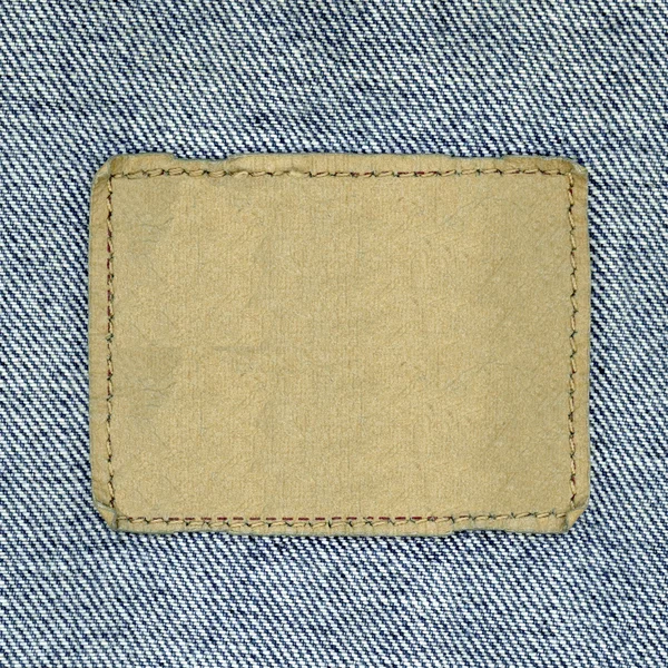 Etiqueta de calça de couro em branco costurada em uma calça azul . — Fotografia de Stock