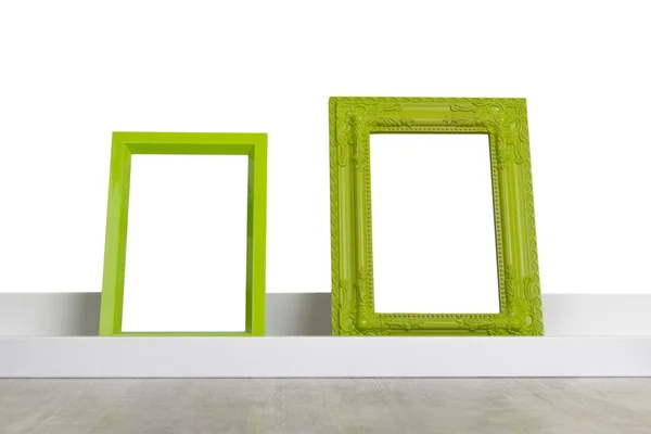 Groene afbeeldingsframes op de plank — Stockfoto