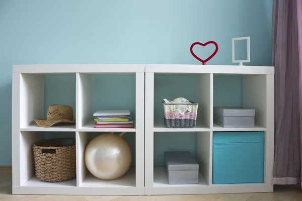 Beautiful white shelves with different home related objects — Stock Photo, Image