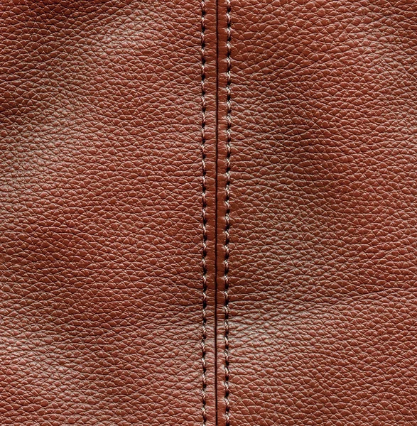 Brunt läder texturerat bakgrund, stygn — Stockfoto