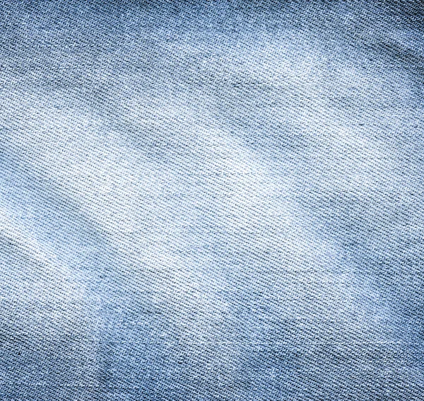 Ношенная ткань из синей джинсы — стоковое фото