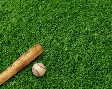 Baseball bat and ball on green turf background clipart