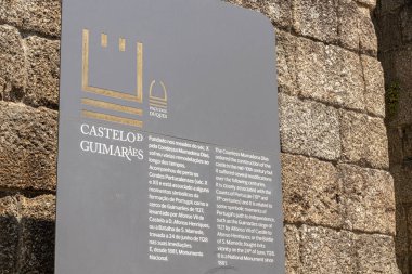 Guimaraes, Portugal. Information sign at the Castelo de Guimaraes (Guimaraes Castle), 10th century medieval castle