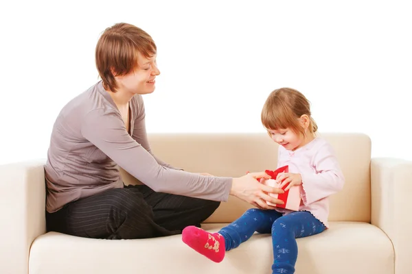 Mom giving a gift to his little daughter. Isolated — Stock Photo, Image