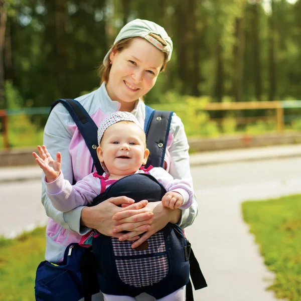 Young and her daughter in a sling