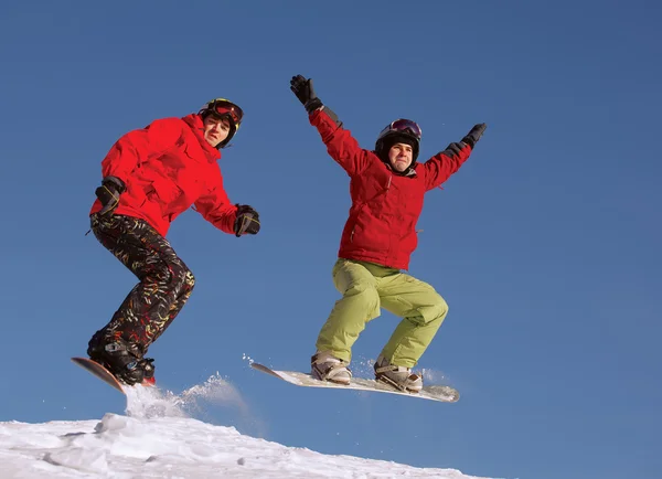 Dois snowboarder jumping — Fotografia de Stock